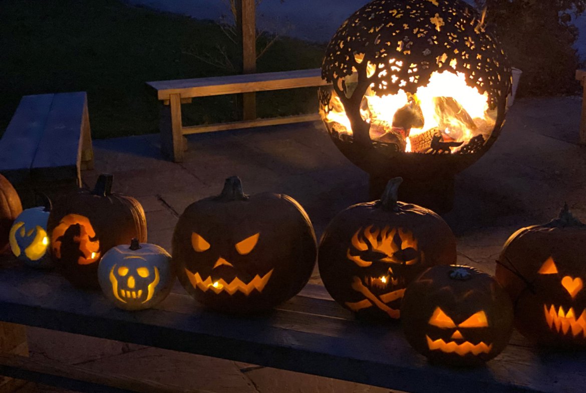 Halloween pumpkins and fire pit at night