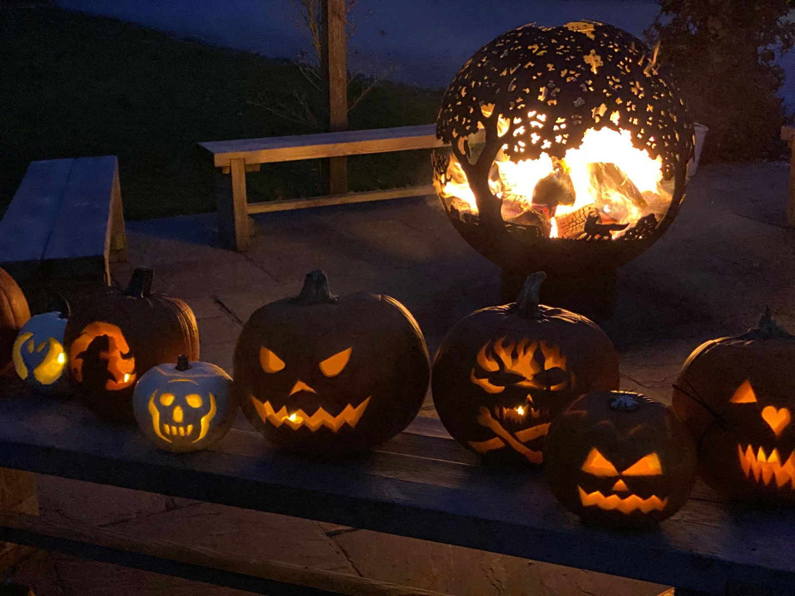 Halloween pumpkins and fire pit at night