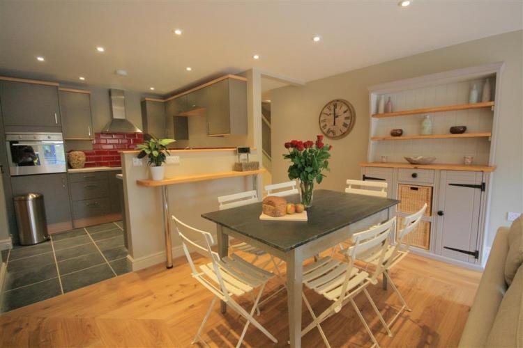 Modern kitchen with dining table and flowers