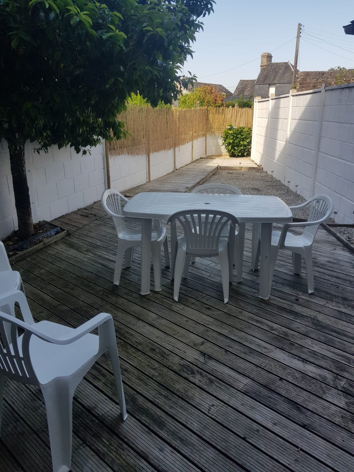 Outdoor seating on a wooden deck with chairs.
