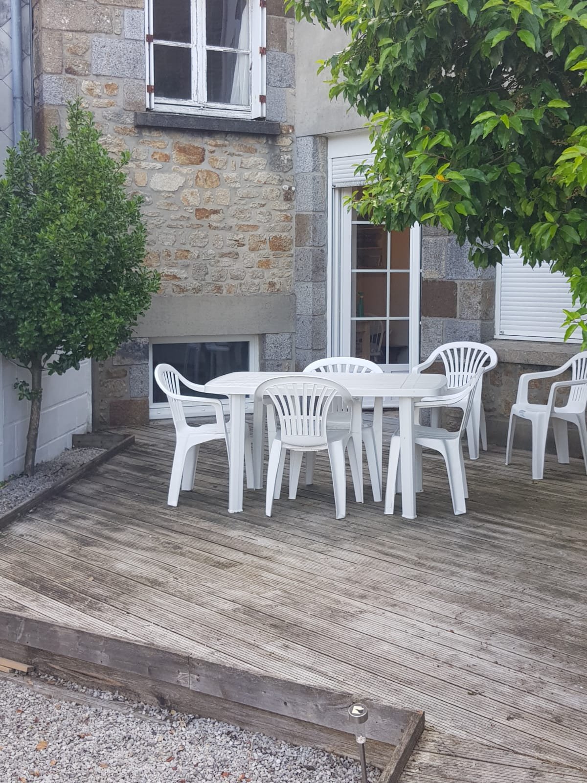 Wooden deck with chairs and table outside house