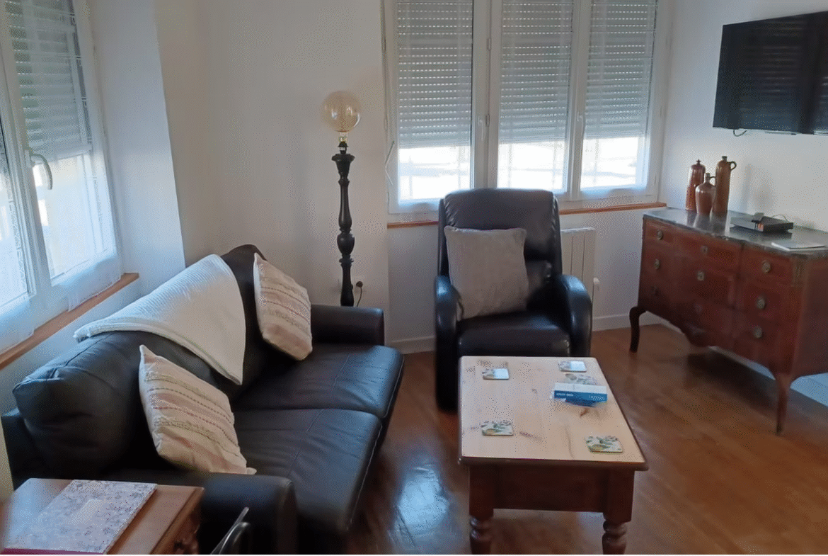 Cosy living room with sofa and armchair.