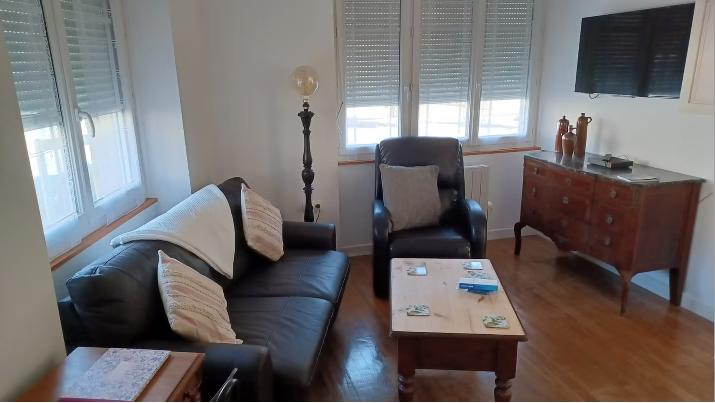 Cosy living room with sofa and armchair.