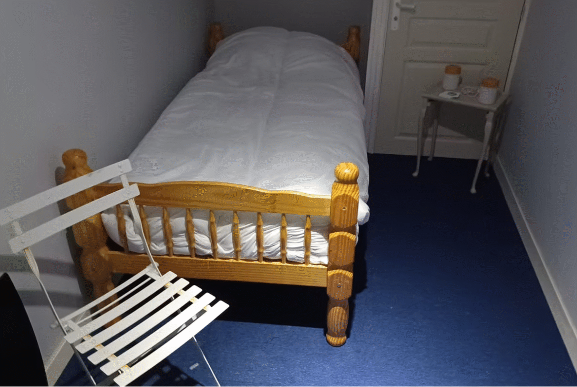 Small bedroom with single bed and chair