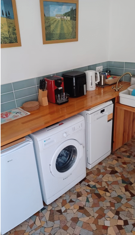 Kitchen corner with appliances and wooden countertop.