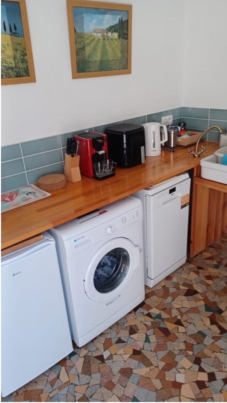 Kitchen corner with appliances and wooden countertop.