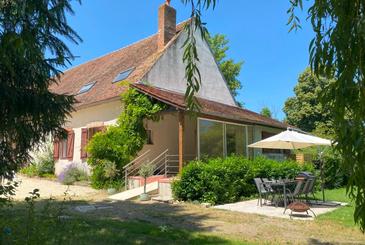 Charming cottage with garden and outdoor seating area.
