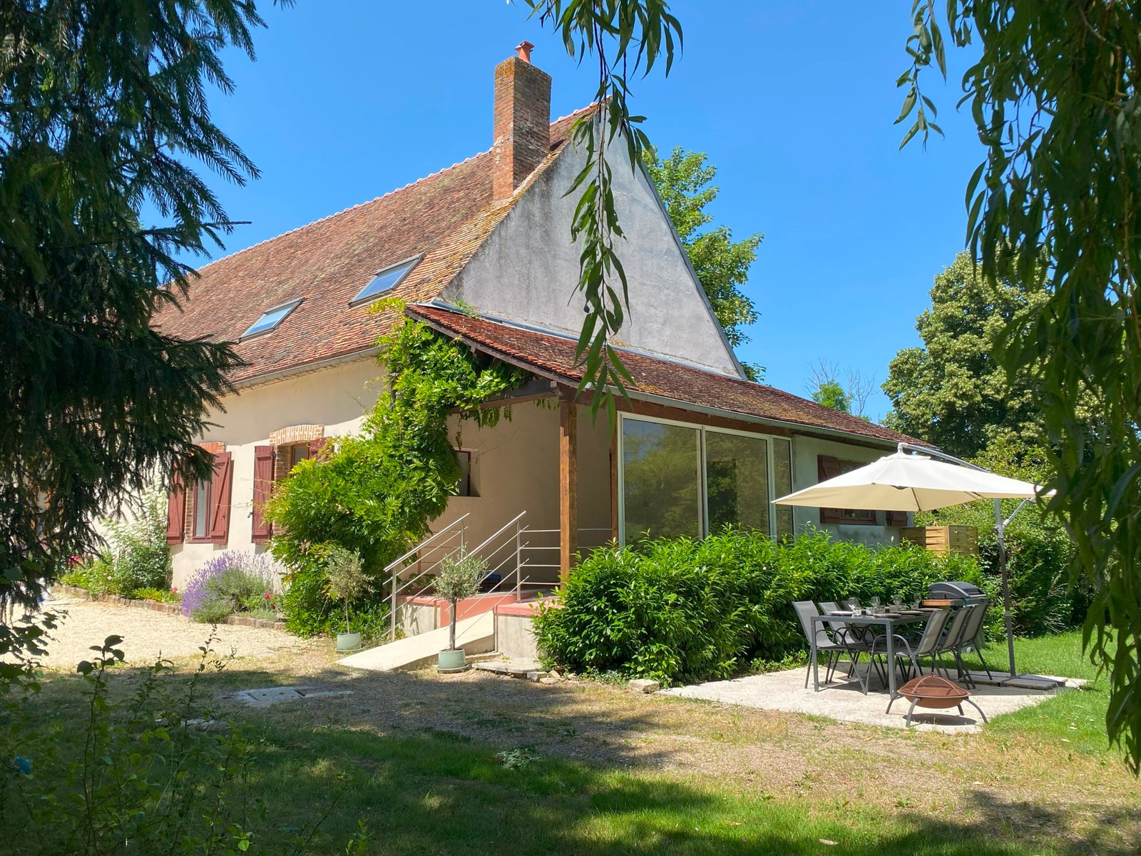 Charming cottage with garden and outdoor seating area.