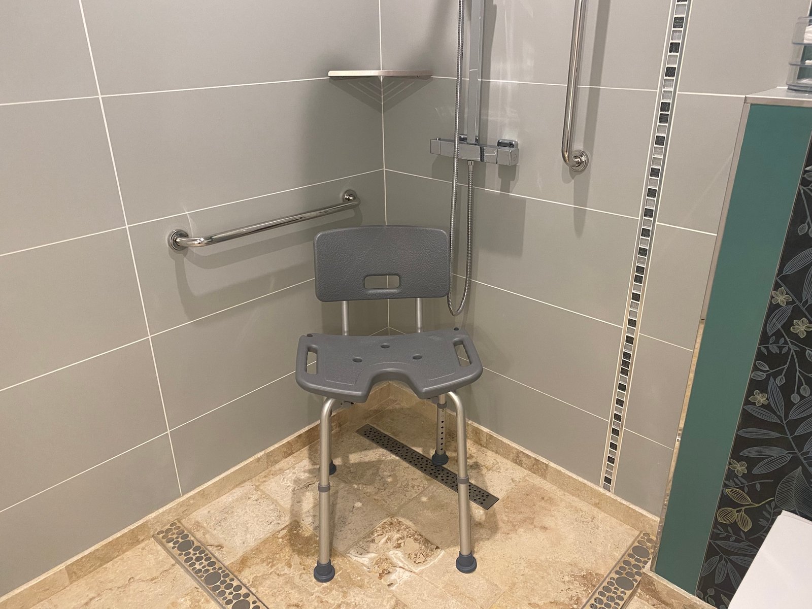 Accessible shower with chair and grab bars