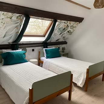 Cosy attic bedroom with twin beds and skylight
