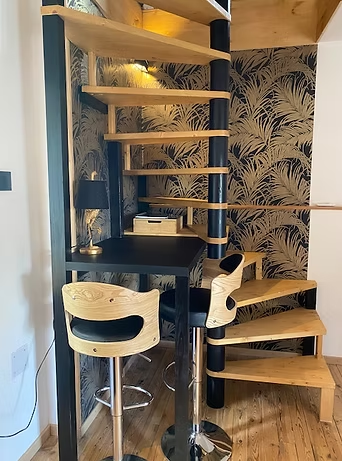 Modern spiral staircase with bar stools and wallpaper