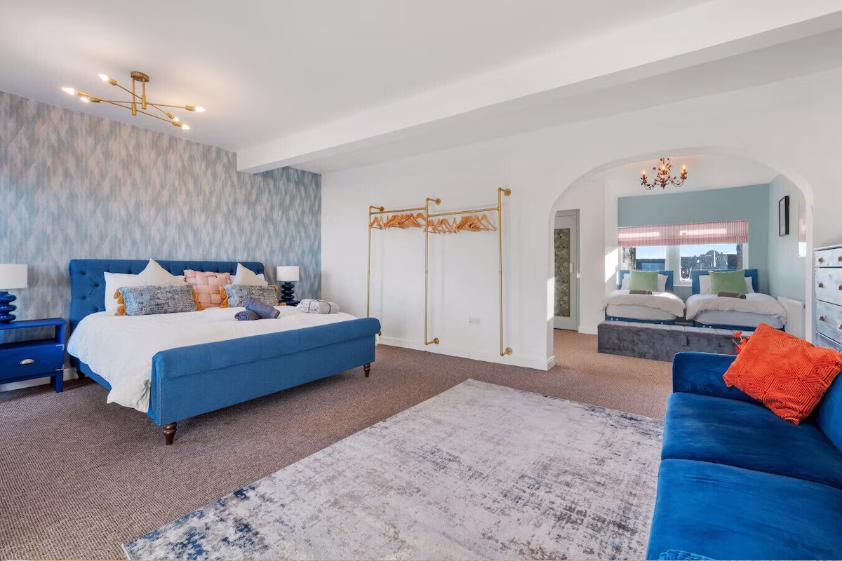 Spacious bedroom with blue and white décor.