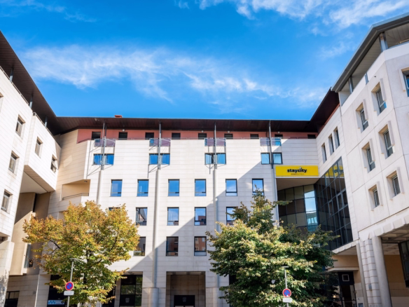 Modern apartment building with blue sky backdrop.