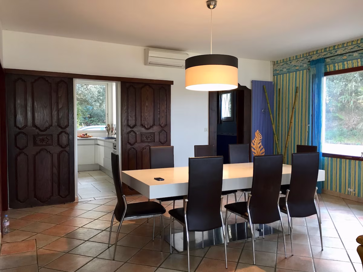 Modern dining room with wooden table, chairs.