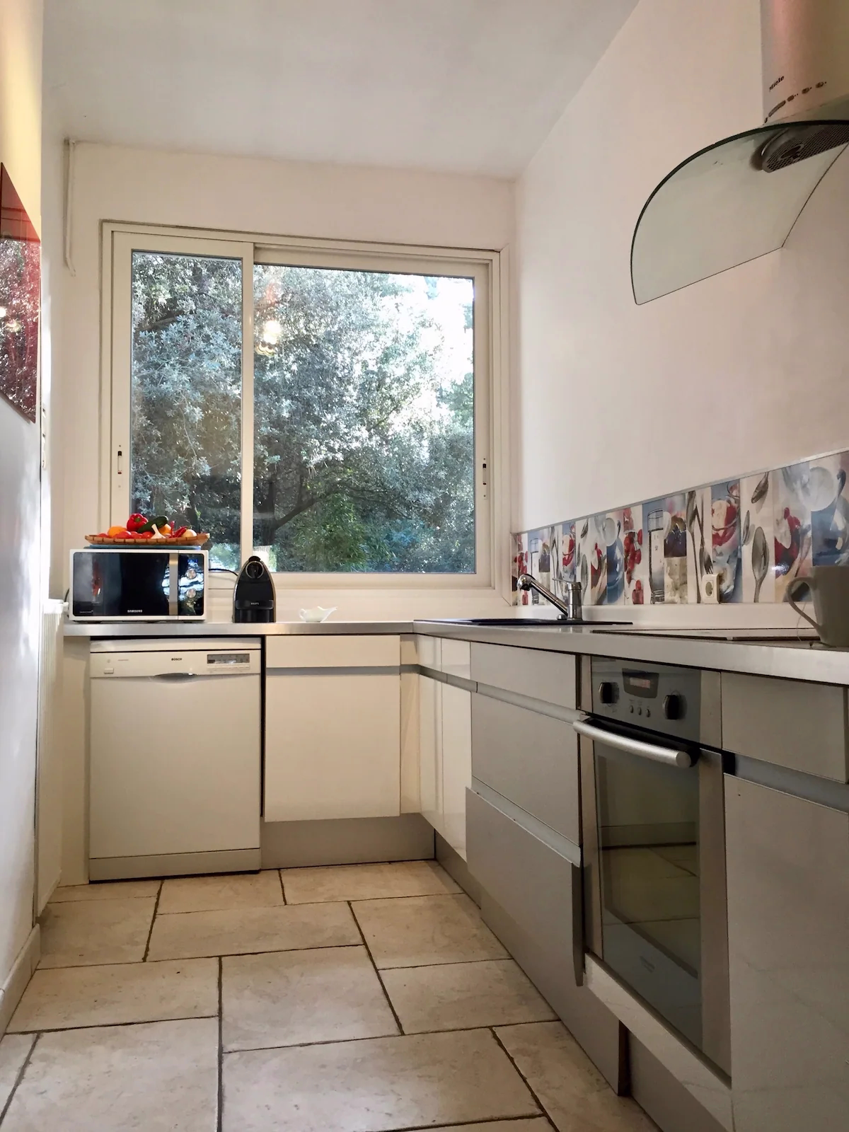 Modern kitchen with window and appliances.