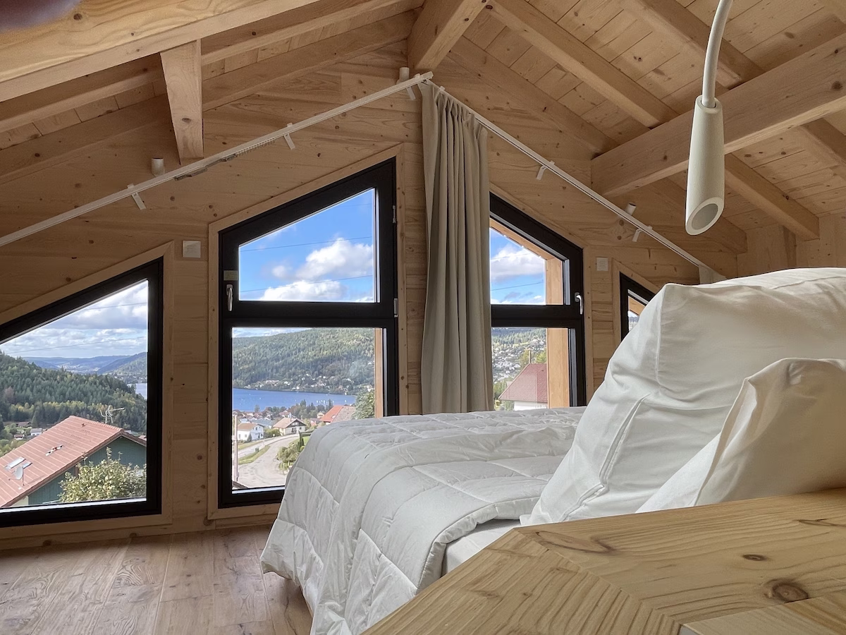 Attic bedroom with scenic mountain and lake view.