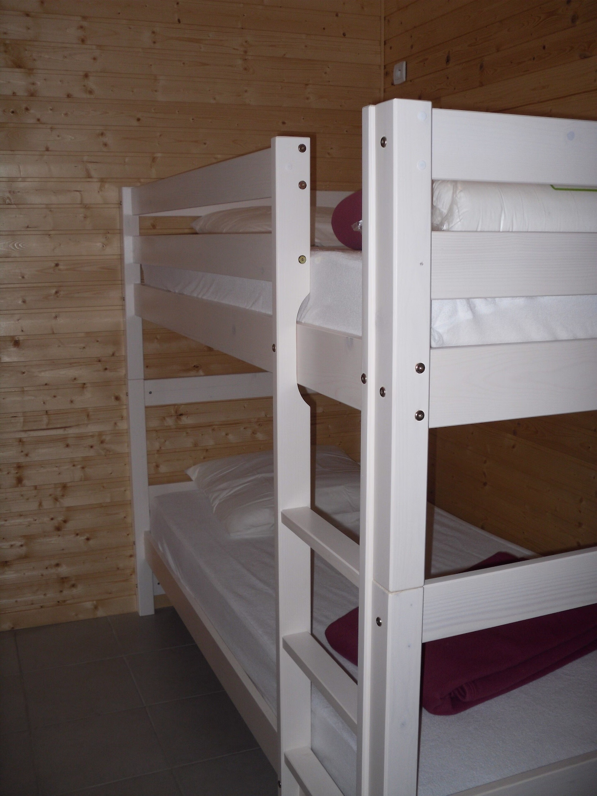 Eco Bunk White bunk beds in wooden cabin room