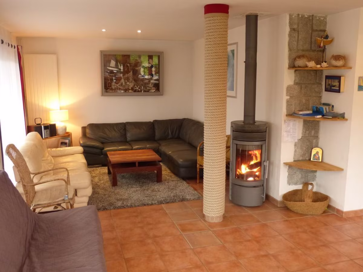 Cosy living room with fireplace and sofas.