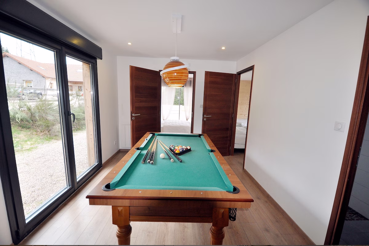 Room with billiard table and cues