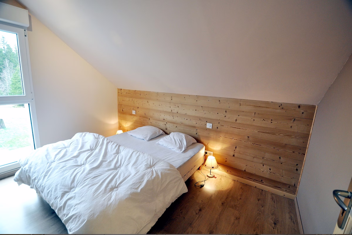 Cosy attic bedroom with double bed and lamps