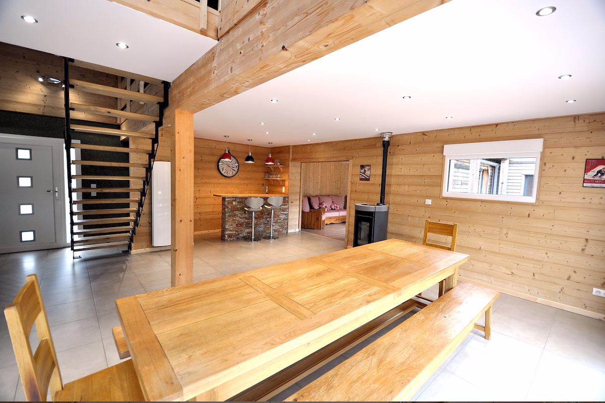 Modern wood interior with dining area and staircase.
