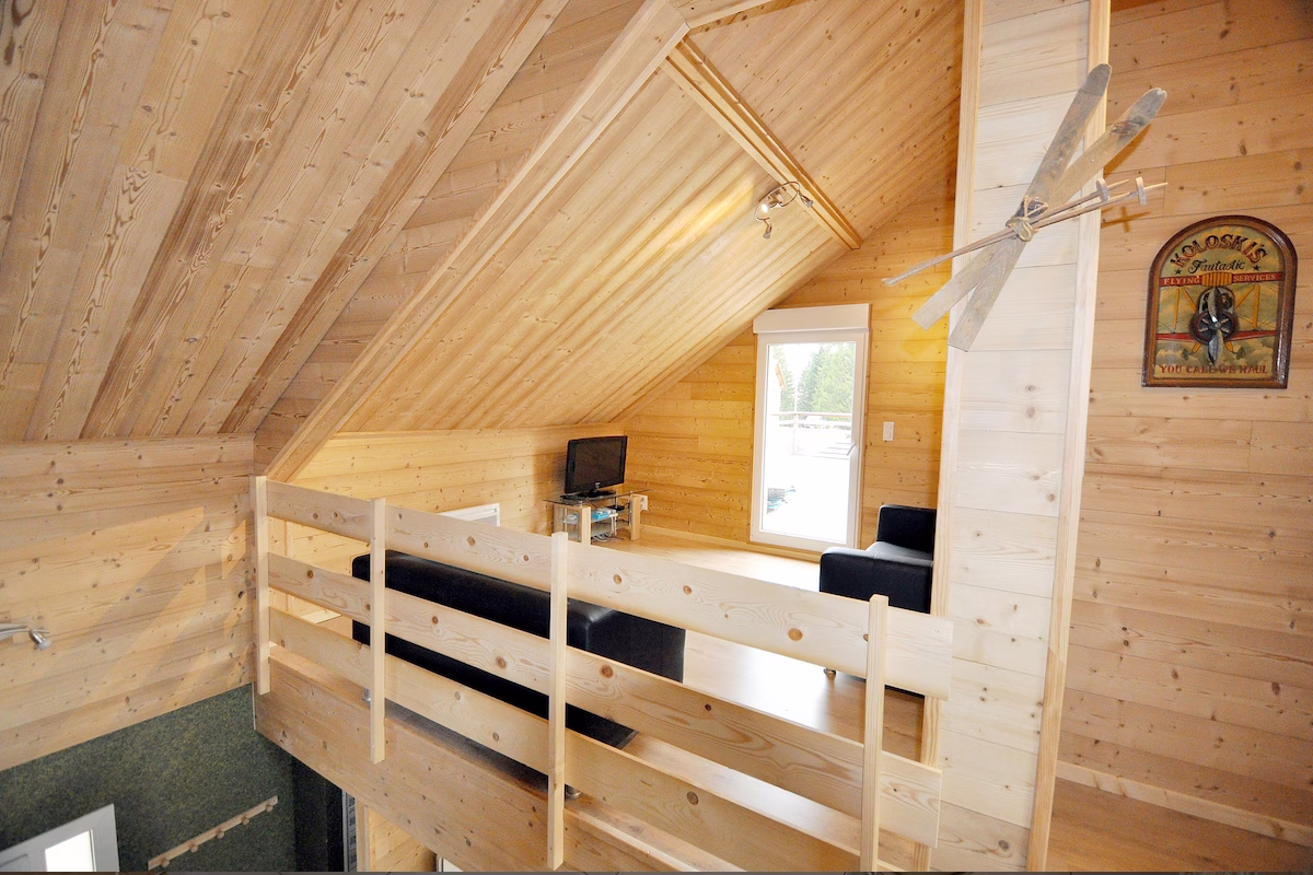 Wooden attic with loft and window view.