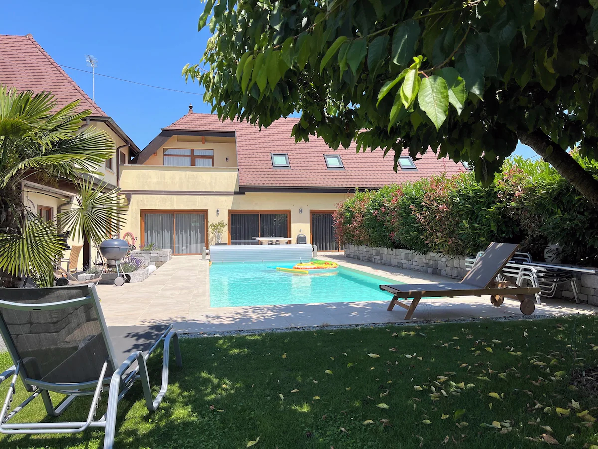 House with pool and garden view.