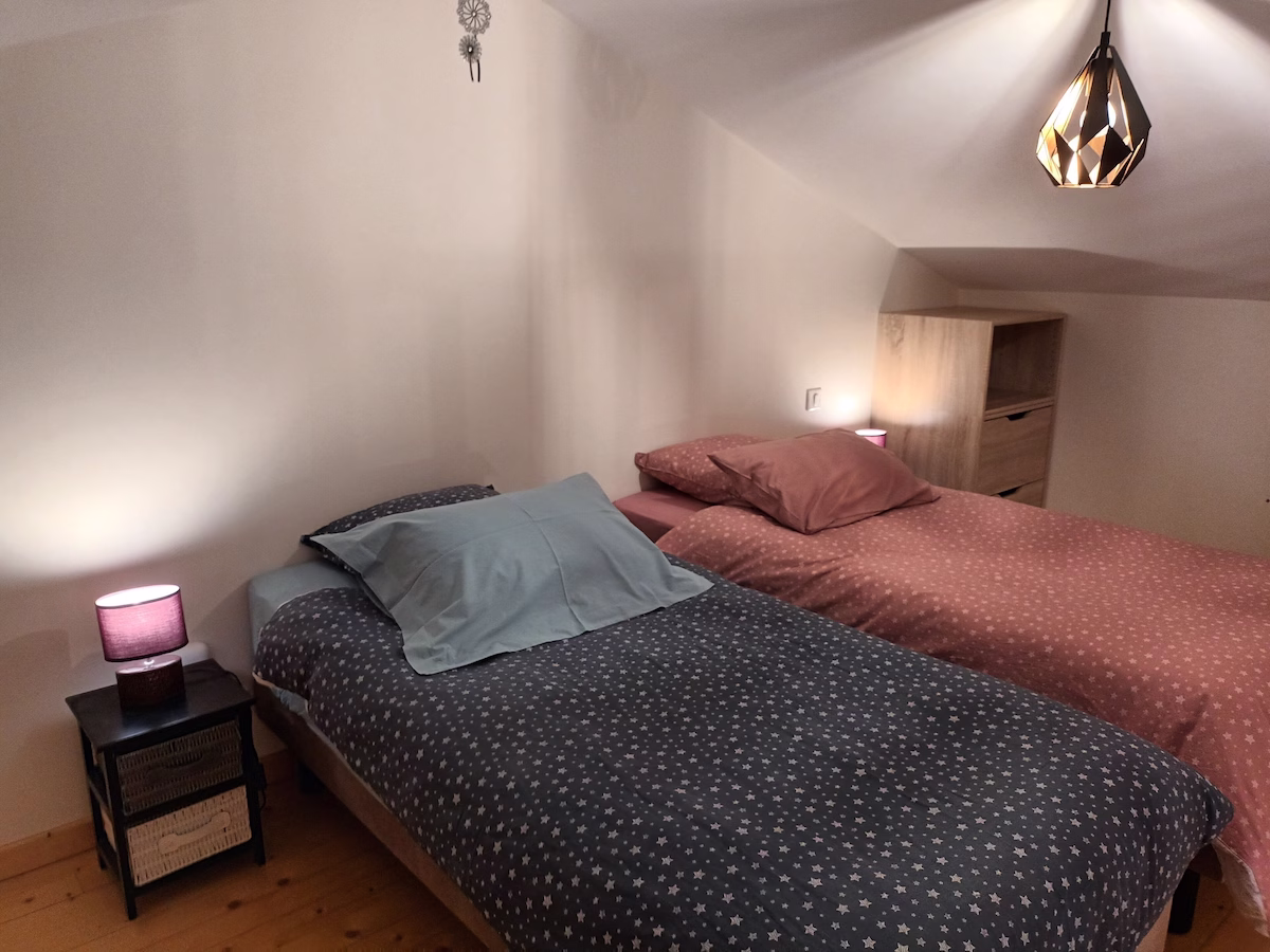 Cosy twin bedroom with warm lighting.