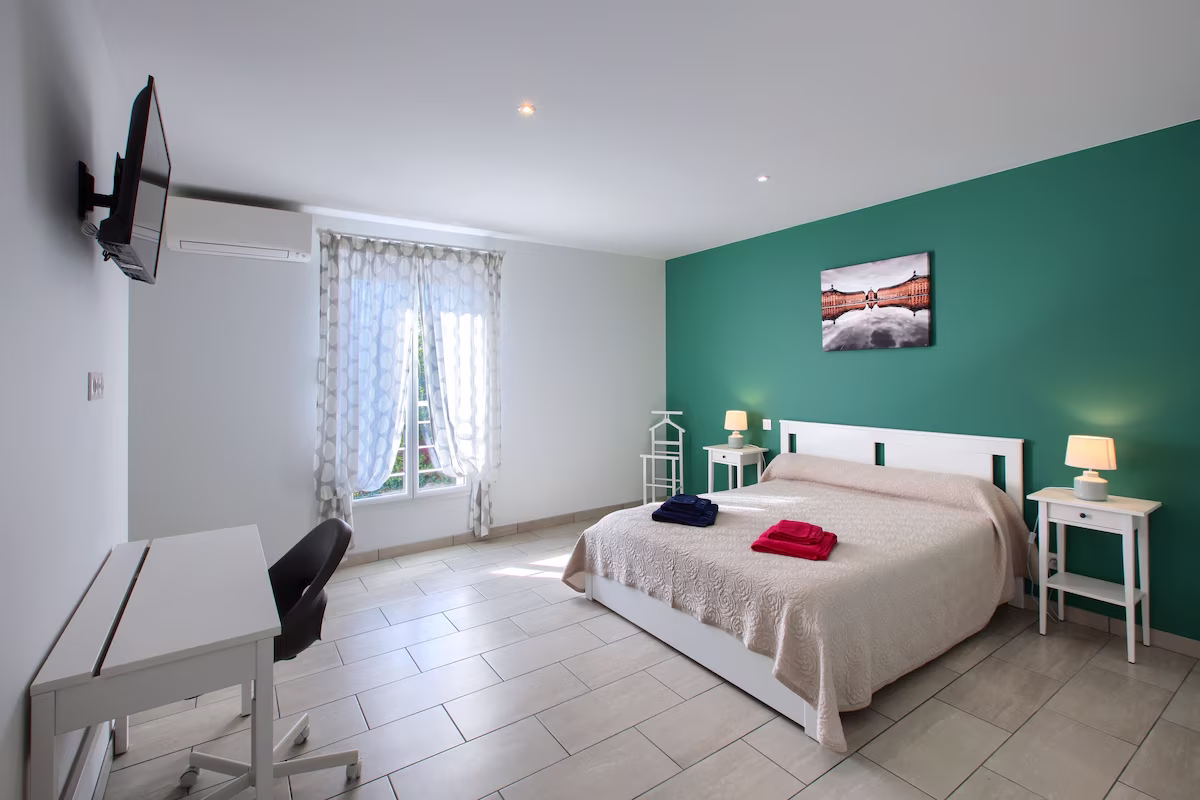 Modern bedroom with double bed and desk