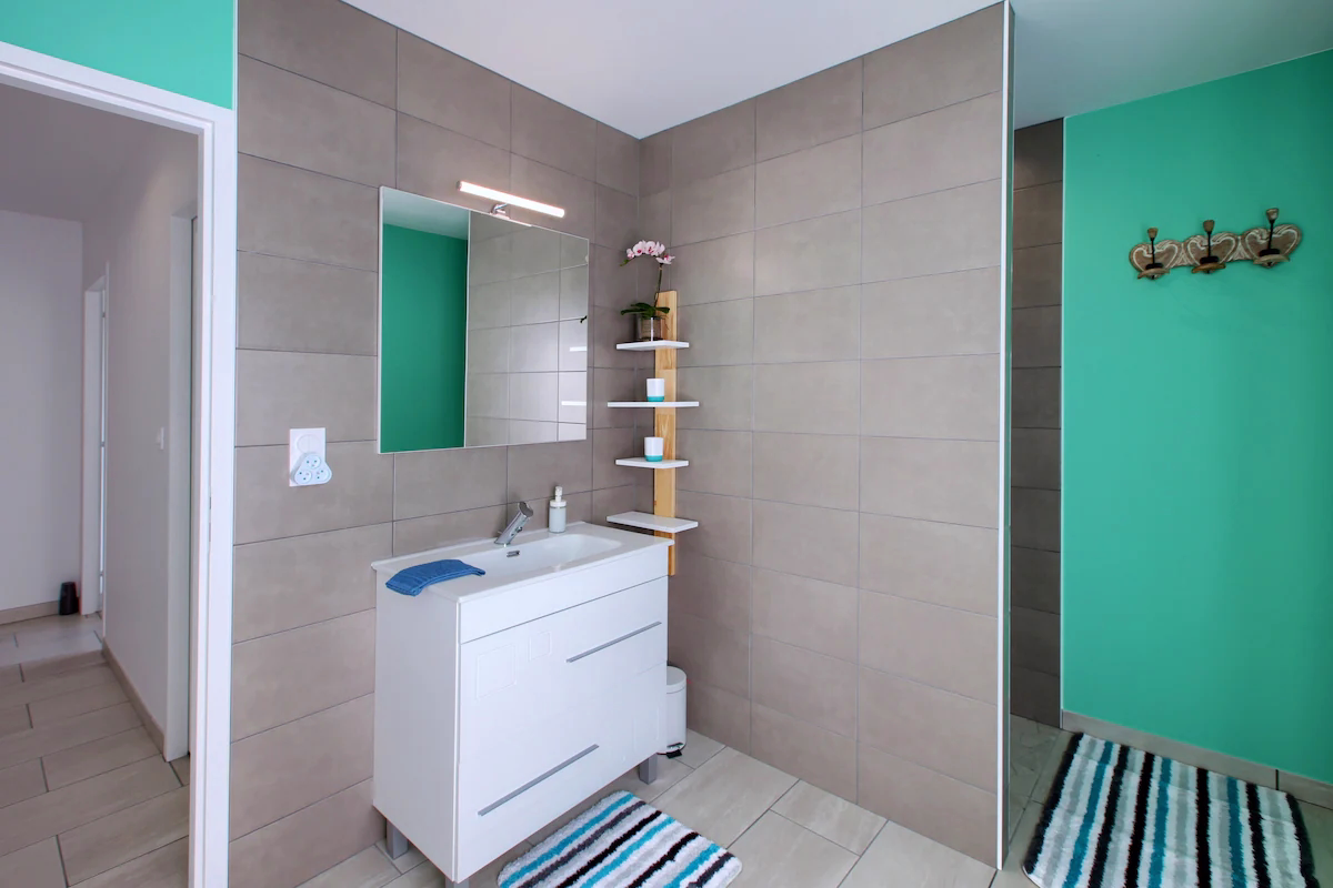 Modern bathroom with teal and beige tiles