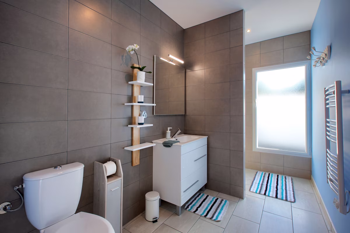Modern bathroom with grey tiles and white fixtures
