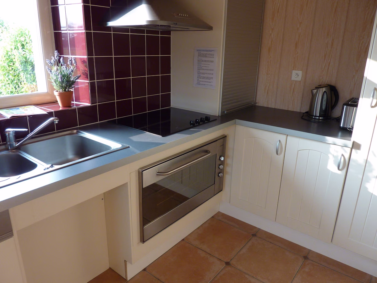Modern kitchen with oven and black hob