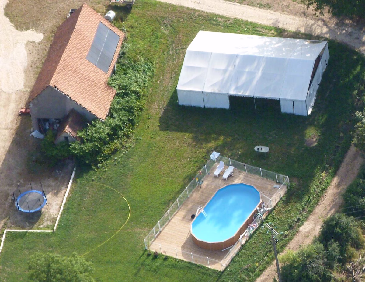Aerial view of garden with pool and tent