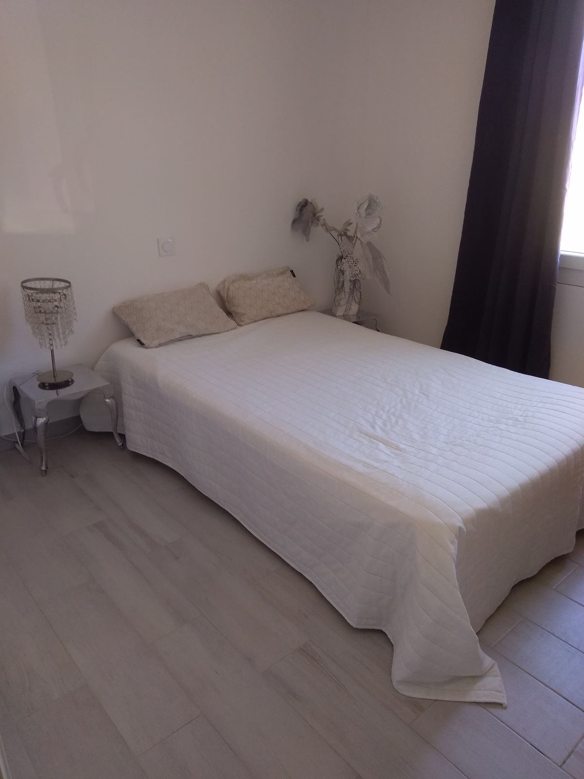 Minimalist bedroom with a single bed and lamp.