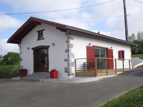Charming cottage with red shutters and greenery