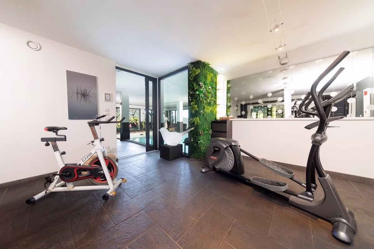 Home gym with exercise bike and elliptical trainer.