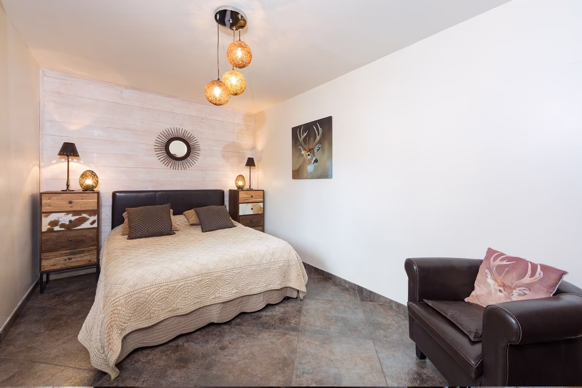 Cosy bedroom with rustic decor and double bed.