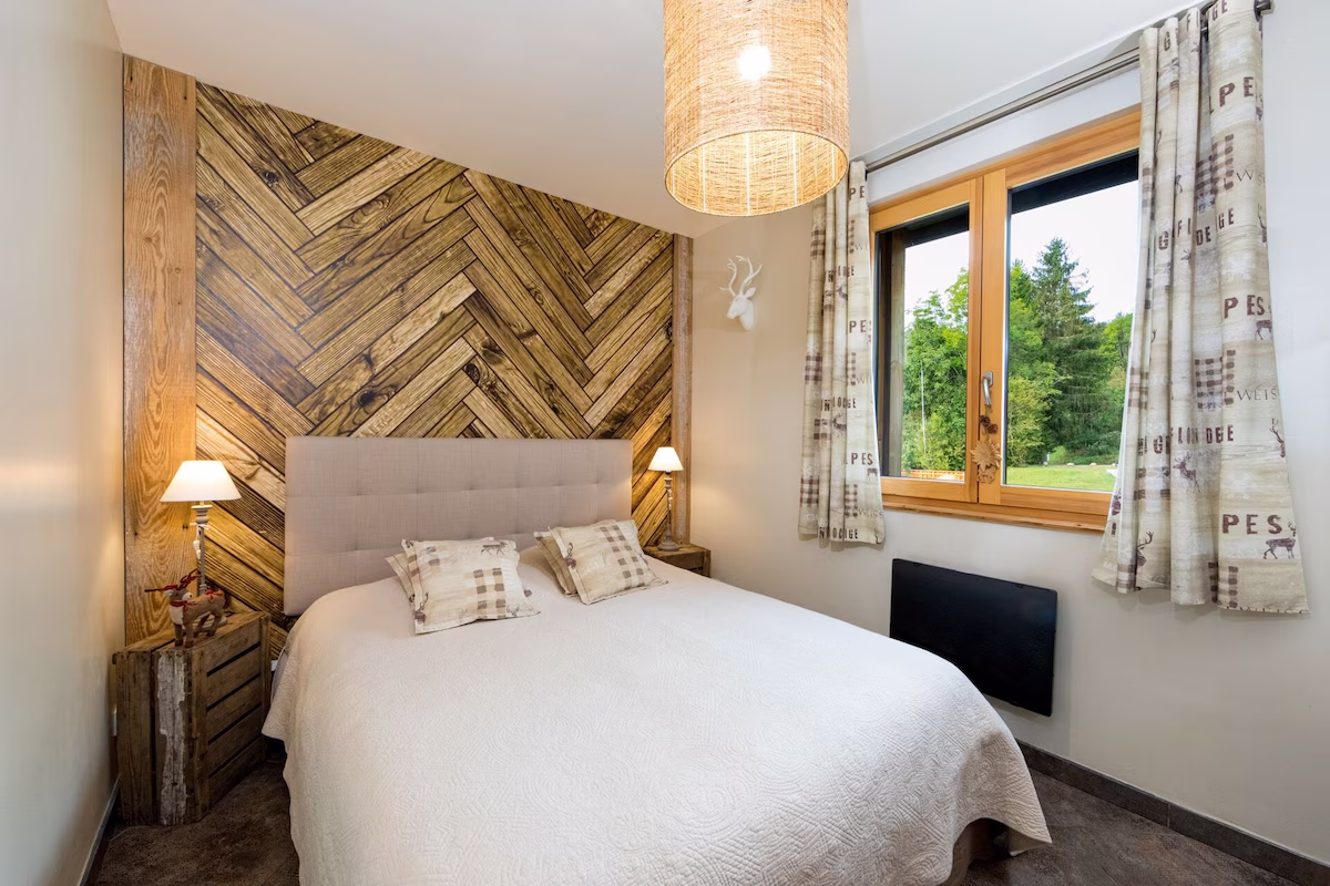 Cosy bedroom with wood panel wall and large window