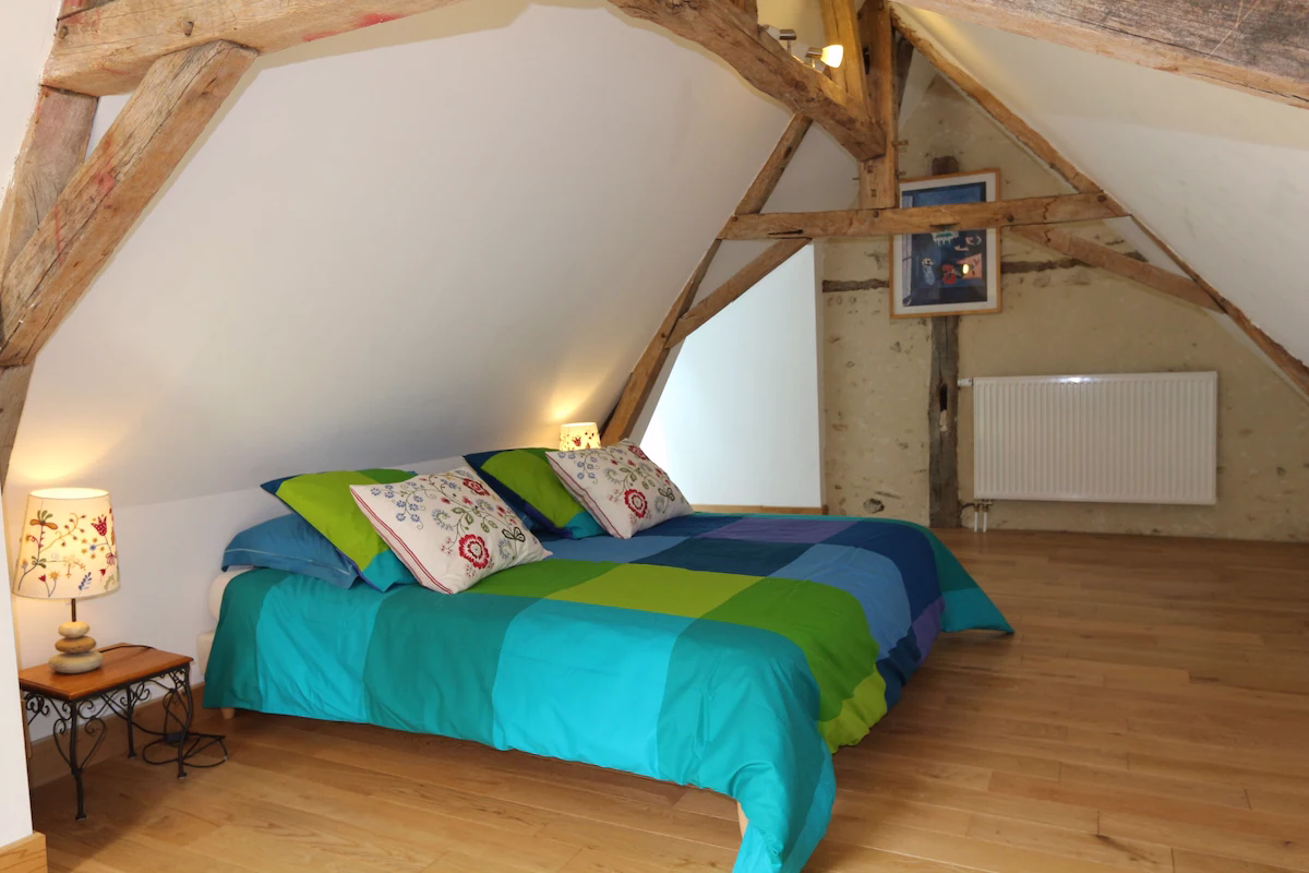 Cosy attic bedroom with wooden beams and double bed